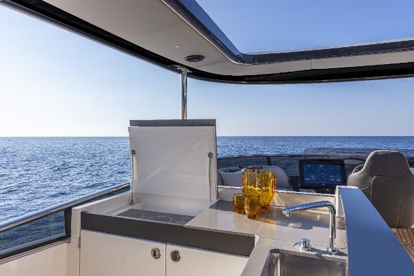 Slide: The Image of Outdoor kitchen on the 2024 Absolute Navetta 64 yacht with ocean view. - 11