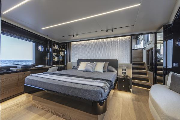 Slide: The Image of Luxurious master bedroom on the 2024 Absolute Navetta 64 yacht with modern decor and ocean view. - 15