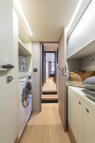 Slide: The Image of Laundry area in the 2024 Absolute Navetta 64 yacht with modern amenities. - 19