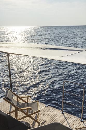 Slide: The Image of 2024 Absolute Navetta 64 yacht deck with ocean view at sunset. - 7