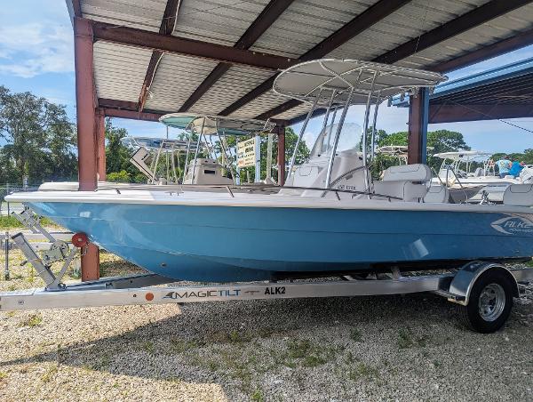 Slide: The Image of 2024 ALK2 Powerboats 22 CRX on a Magic Tilt trailer under a metal canopy. - 0