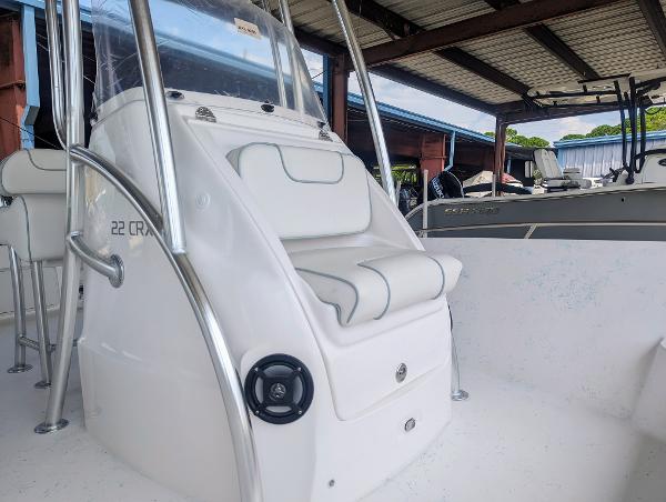 Slide: The Image of 2024 ALK2 Powerboats 22 CRX, white interior, center console, under covered dock. - 11