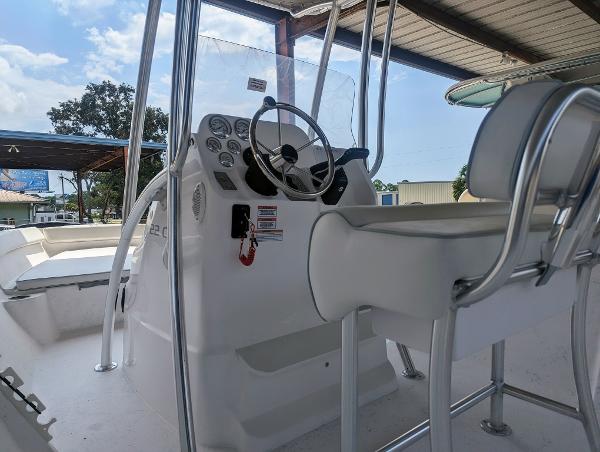Slide: The Image of 2024 ALK2 Powerboats 22 CRX center console with steering wheel and seating. - 16