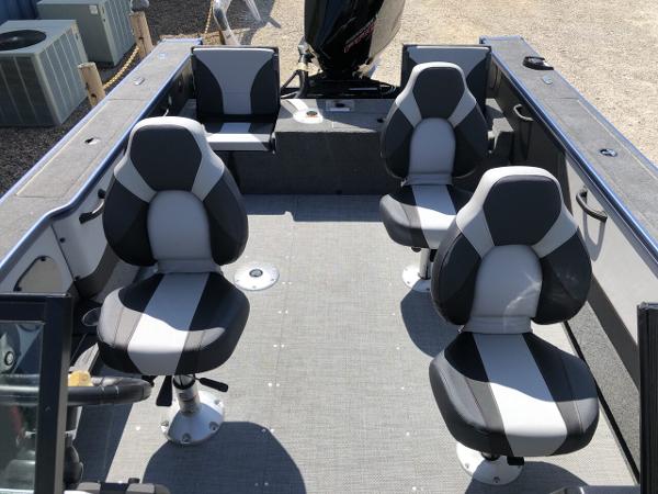 Slide: The Image of 2024 Alumacraft Trophy 195 boat interior with four cushioned seats. - 12
