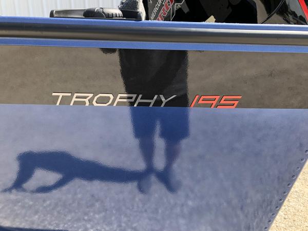 Slide: The Image of 2024 Alumacraft Trophy 195 boat side view with model name. - 4
