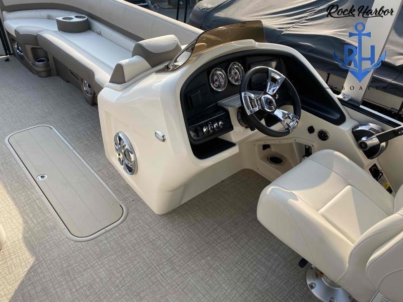 Slide: The Image of 2023 Avalon 2585 Catalina Cruise Funship boat interior with steering console and seating. - 12