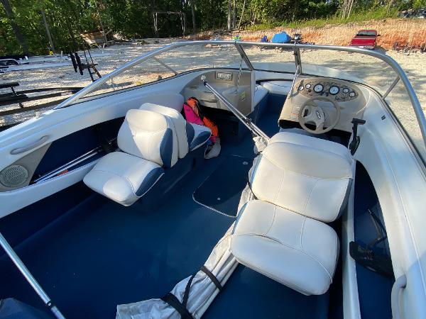 Slide: The Image of 2001 Bayliner 215 Bowrider interior with white and blue seating. - 14