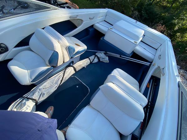 Slide: The Image of 2001 Bayliner 215 Bowrider interior with white and blue seating. - 3