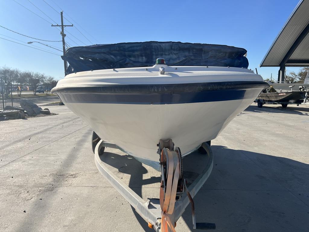 Slide: The Image of 2004 Bayliner 175 boat on trailer, parked outdoors under clear blue sky. - 6