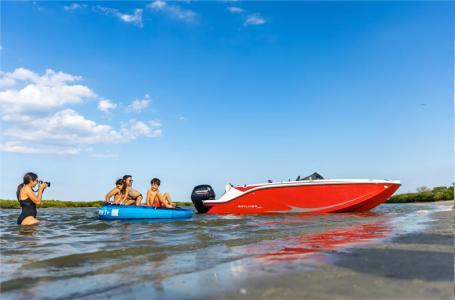Slide: The Image of 2024 Bayliner Element M19 boat on water with people enjoying nearby. - 6