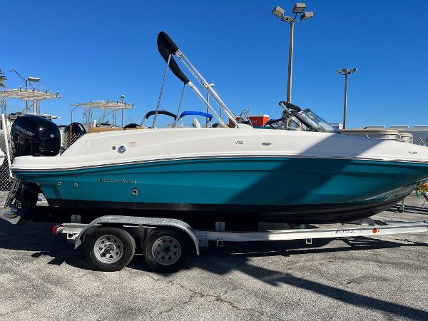 Slide: The Image of 2020 Bayliner VR5 boat on a trailer in a marina. - 2