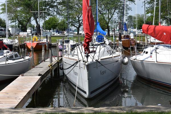 Slide: The Image of Beneteau First 30 sailboat docked at marina, 2012 model, surrounded by other boats. - 1