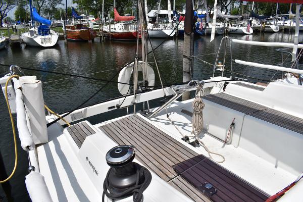 Slide: The Image of 2012 Beneteau First 30 sailboat docked at a marina, showcasing its deck and seating area. - 10