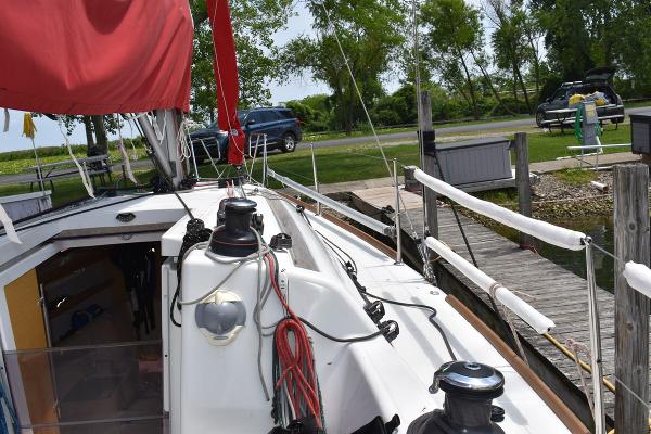 Slide: The Image of 2012 Beneteau First 30 sailboat docked, showing deck and rigging. - 11