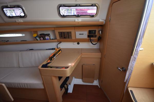 Slide: The Image of Interior of 2012 Beneteau First 30 sailboat with navigation station and seating area. - 22