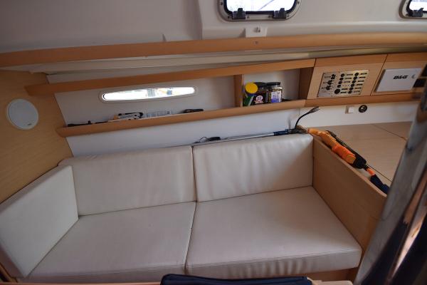 Slide: The Image of Interior of 2012 Beneteau First 30 sailboat with white cushioned seating. - 23