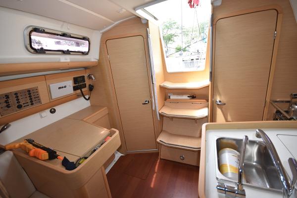 Slide: The Image of Interior of a 2012 Beneteau First 30 sailboat with wooden cabinetry and navigation station. - 26