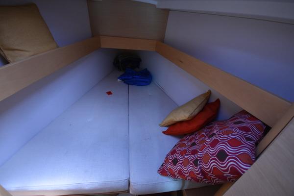 Slide: The Image of Cozy cabin interior of 2012 Beneteau First 30 sailboat with colorful cushions. - 28