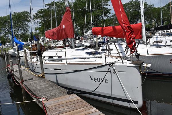 Slide: The Image of 2012 Beneteau First 30 sailboat docked with red sails. - 3