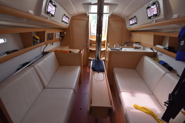 Slide: The Image of Interior of 2012 Beneteau First 30 sailboat with beige seating and wooden finishes. - 30