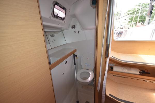 Slide: The Image of Beneteau First 30 2012 sailboat interior bathroom with toilet and window. - 32