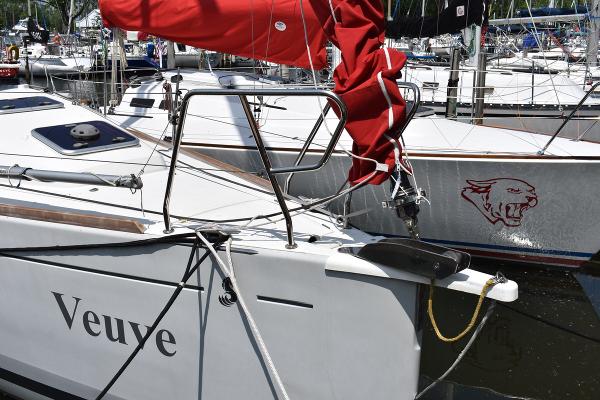 Slide: The Image of Beneteau First 30 sailboat, 2012 model, docked with red sail cover, named Veuve. - 4