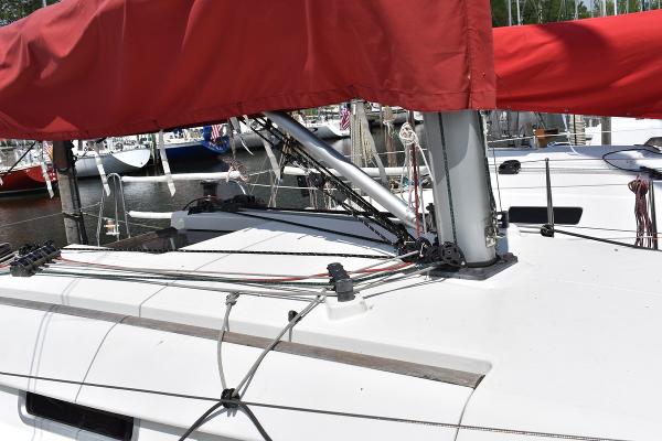 Slide: The Image of Beneteau First 30 sailboat, 2012 model, with red sail cover docked at marina. - 8