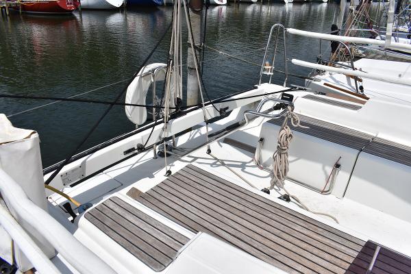 Slide: The Image of Beneteau First 30 (2012) sailboat deck at marina, featuring teak flooring and rigging. - 9