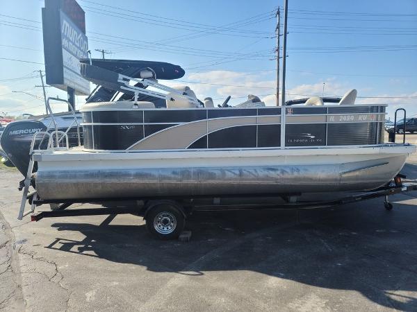 Slide: The Image of 2016 Bennington 20 SS pontoon boat on trailer in parking lot. - 1