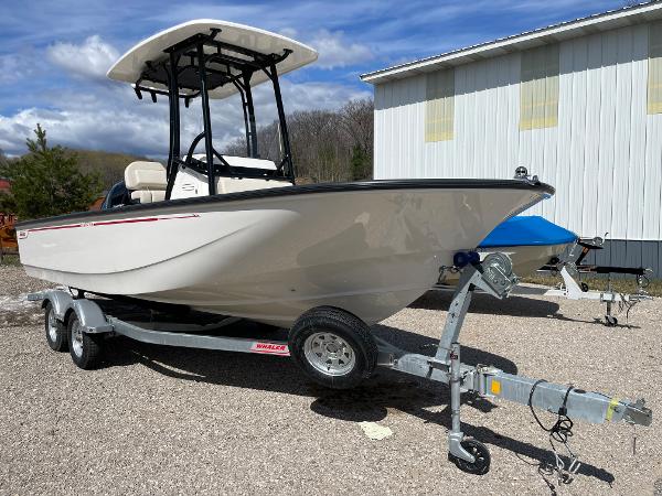 Slide: The Image of 2023 Boston Whaler 210 Montauk boat on a trailer, parked outdoors. - 8