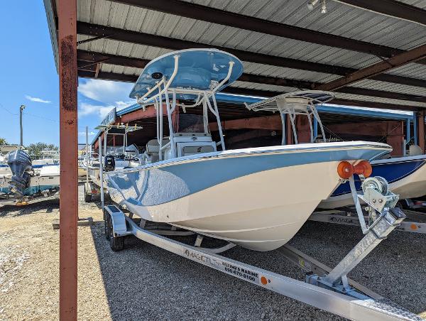 Slide: The Image of 2022 Carolina Skiff 24 Ultra Elite boat on trailer under shelter. - 0