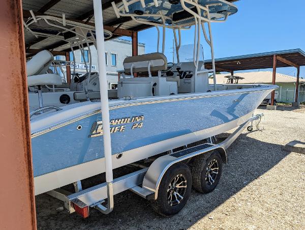 Slide: The Image of 2022 Carolina Skiff 24 Ultra Elite boat on a trailer in a covered storage area. - 2