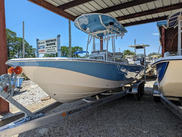 Slide: The Image of 2022 Carolina Skiff 24 Ultra Elite boat on a trailer at a marina. - 3