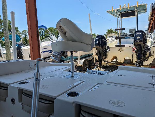 Slide: The Image of 2022 Carolina Skiff 24 Ultra Elite boat with dual outboard motors in a marina. - 9