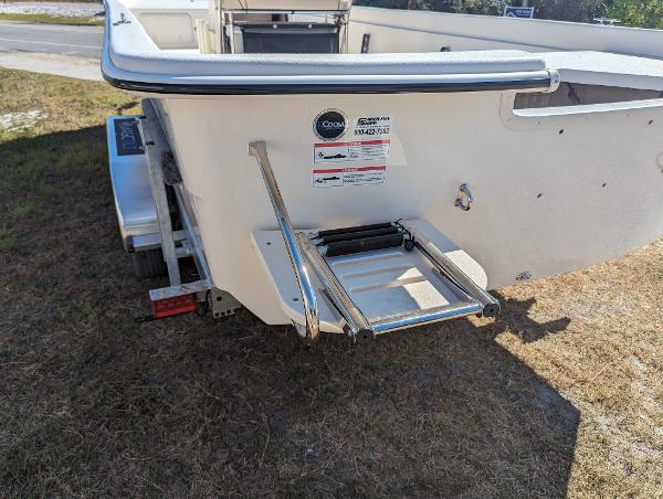 Slide: The Image of 2024 Carolina Skiff E Series 24ft CC boat stern with ladder and trailer. - 3