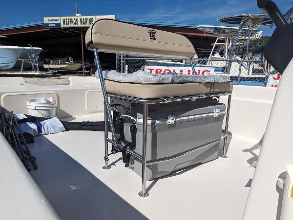 Slide: The Image of 2024 Carolina Skiff E Series 24ft CC boat with cushioned seating and storage. - 5