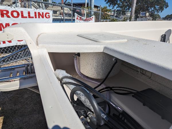 Slide: The Image of 2024 Carolina Skiff E Series 24ft CC boat interior wiring and storage compartment. - 8