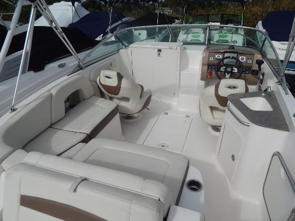Slide: The Image of 2013 Chaparral 225 SSi boat interior with white and beige seating. - 11