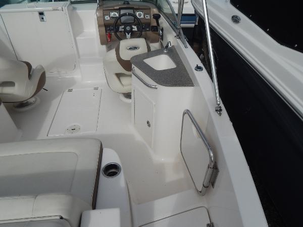 Slide: The Image of Interior of a 2013 Chaparral 225 SSi boat with seating and helm. - 12