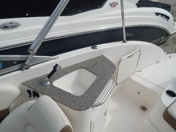 Slide: The Image of 2013 Chaparral 225 SSi boat interior with sink and seating area. - 13