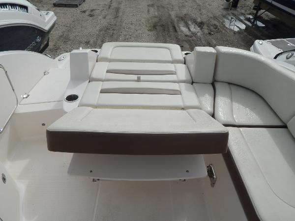 Slide: The Image of 2013 Chaparral 225 SSi boat with white and brown cushioned seating. - 15