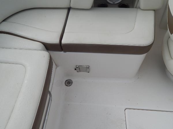Slide: The Image of Interior seating of a 2013 Chaparral 225 SSi boat with white and brown upholstery. - 23