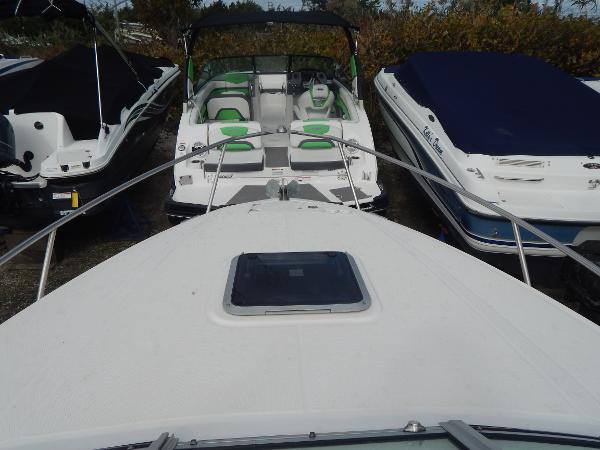 Slide: The Image of 2013 Chaparral 225 SSi boat docked among other boats. - 25