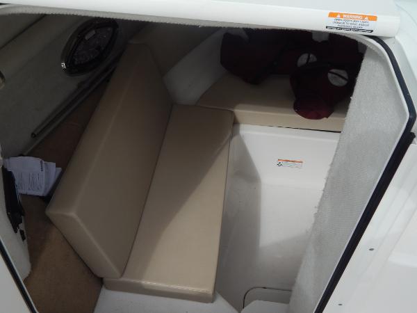 Slide: The Image of 2013 Chaparral 225 SSi boat interior cabin with beige seating. - 27