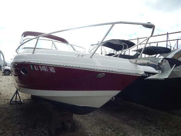 Slide: The Image of 2013 Chaparral 225 SSi boat with red and white hull on dry dock. - 3