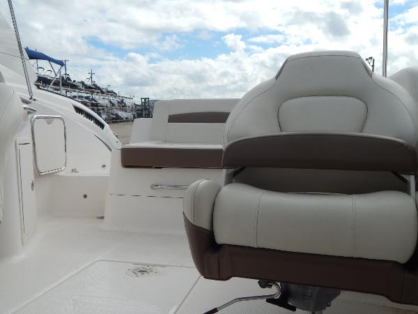 Slide: The Image of 2013 Chaparral 225 SSi boat interior with white and brown seating. - 30