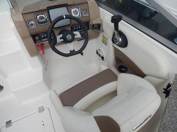 Slide: The Image of 2013 Chaparral 225 SSi boat cockpit with steering wheel and control panel. - 32