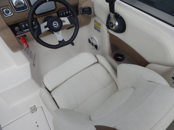Slide: The Image of 2013 Chaparral 225 SSi boat cockpit with steering wheel and white seating. - 33