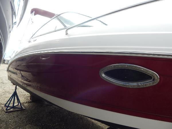 Slide: The Image of 2013 Chaparral 225 SSi boat, red and white hull, side view. - 4