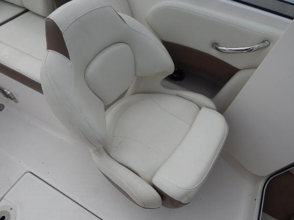 Slide: The Image of 2013 Chaparral 225 SSi boat interior, white and brown captain's chair. - 42